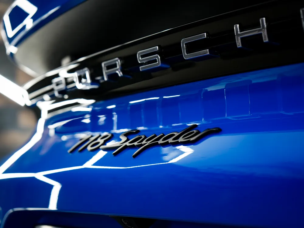 Porsche-Schriftzug und 718-Spyder-Emblem im versiegelten Lack